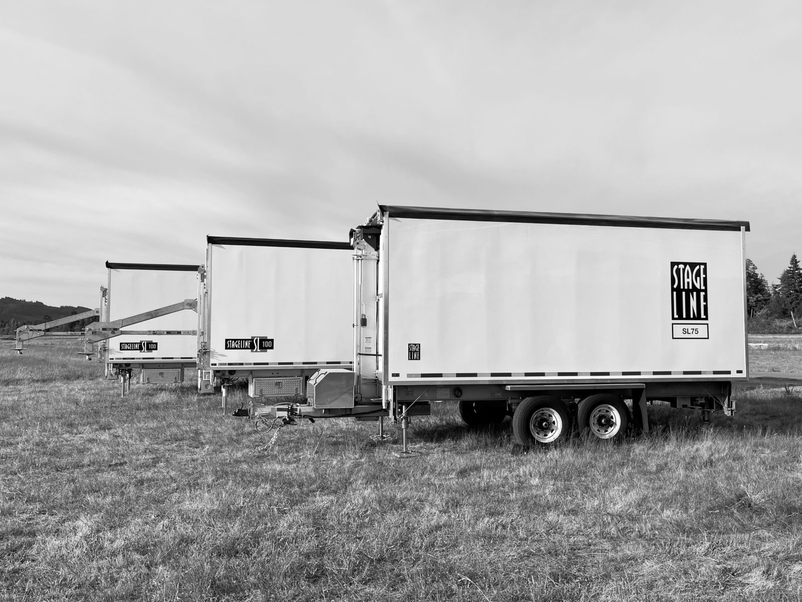 Stageline mobile stage trailers lined up in a field