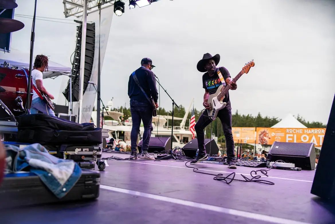 Band performing on a mobile stage deck at an outdoor market
