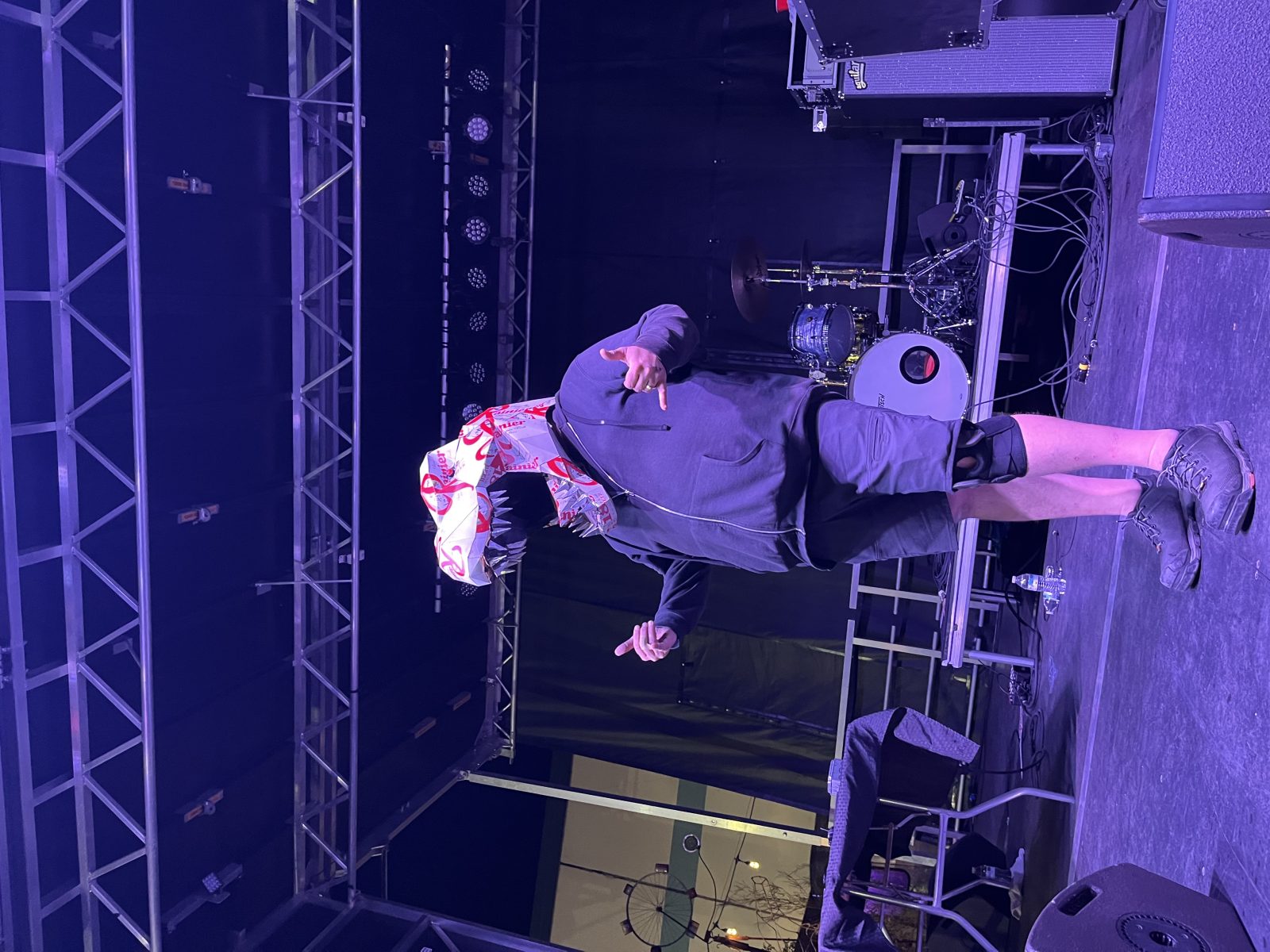 Crew member in a dinosaur mask on a Put A Stage On It stage
