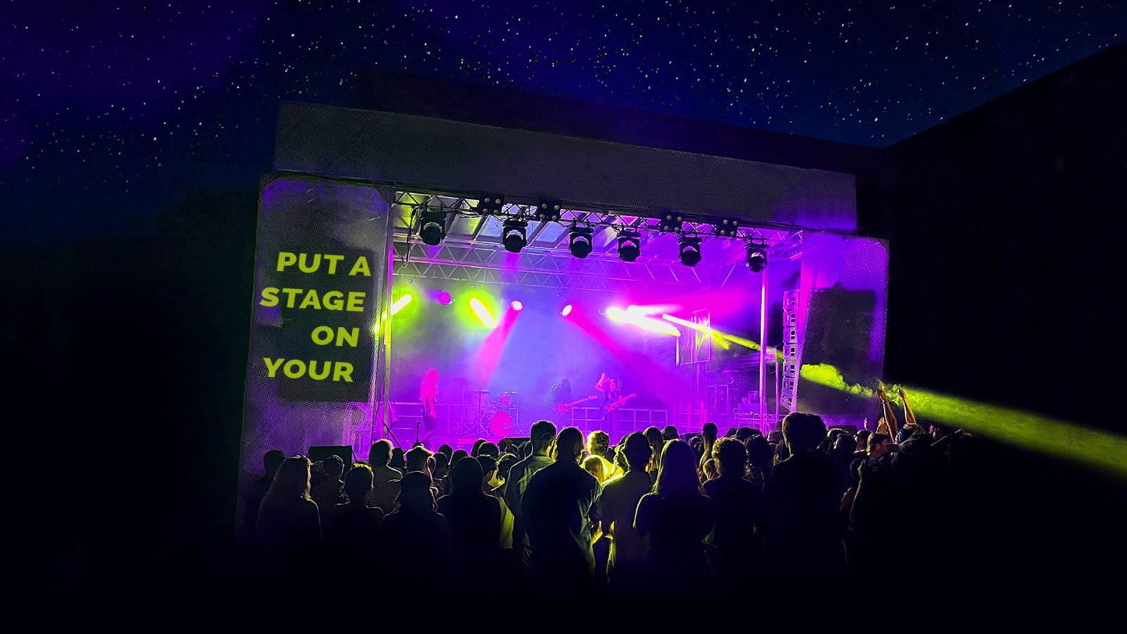 Crowd in front of a Put A Stage On It mobile stage lit purple at night
